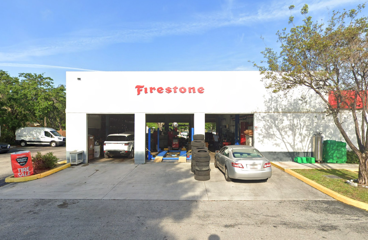 West Boynton Tire and Auto storefront — open service bays with cars being worked on, Firestone Affiliated Retailer